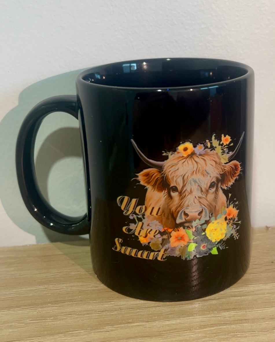 Highland cow with floral coffee mug